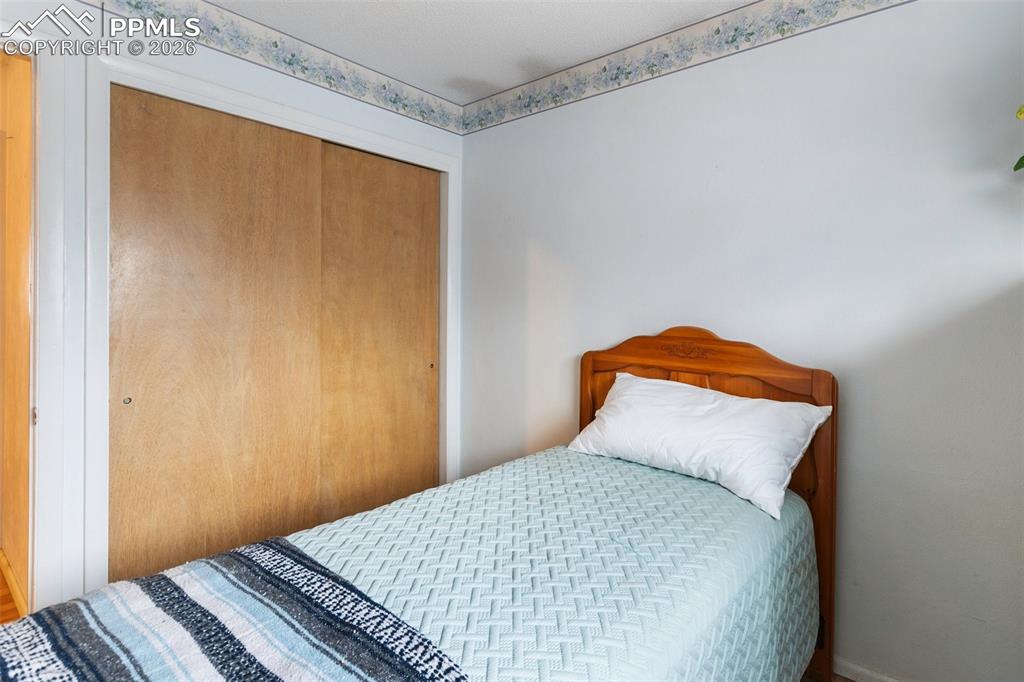 Image 25 of 34: One of 3 bedrooms on the upper level - features wood flooring