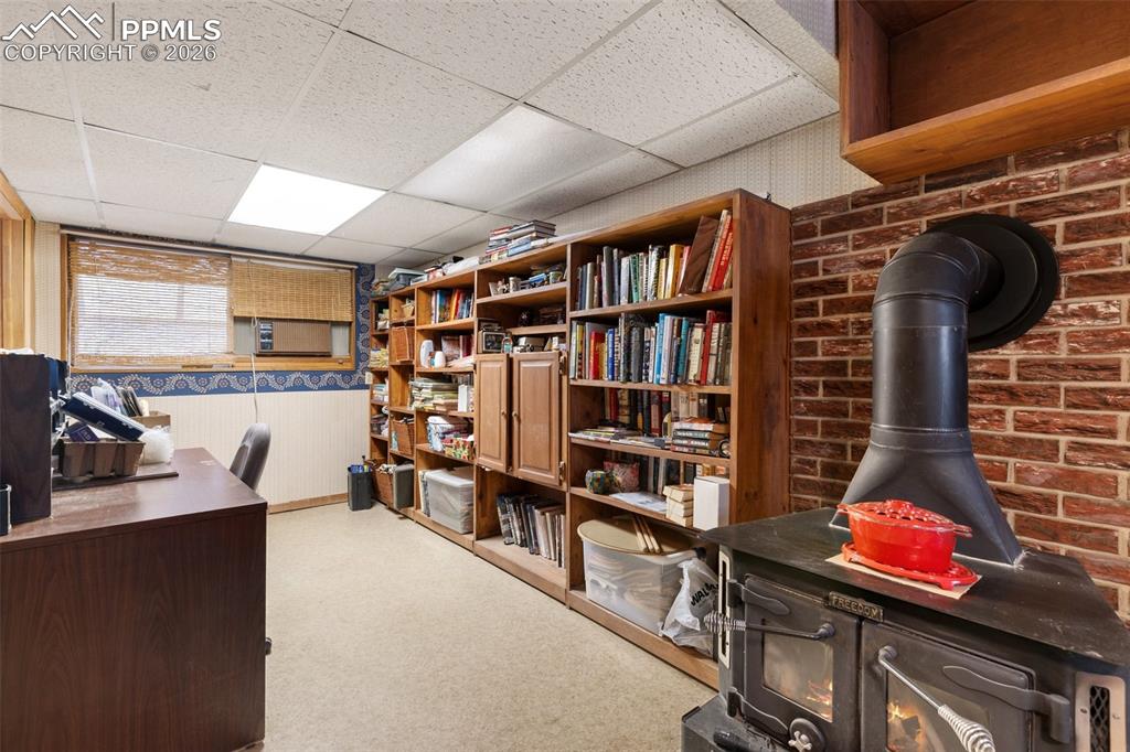 Image 28 of 34: Basement family room - features a wood burning stove and built-ins