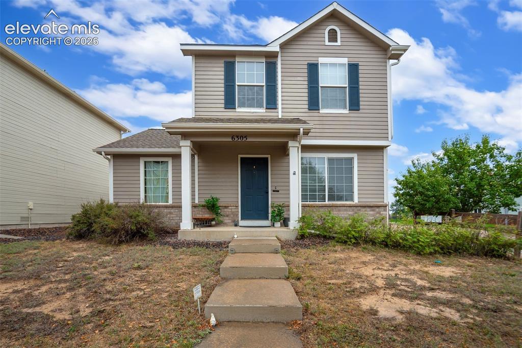 Caption: Two-story residence featuring light-toned siding and dark shutters