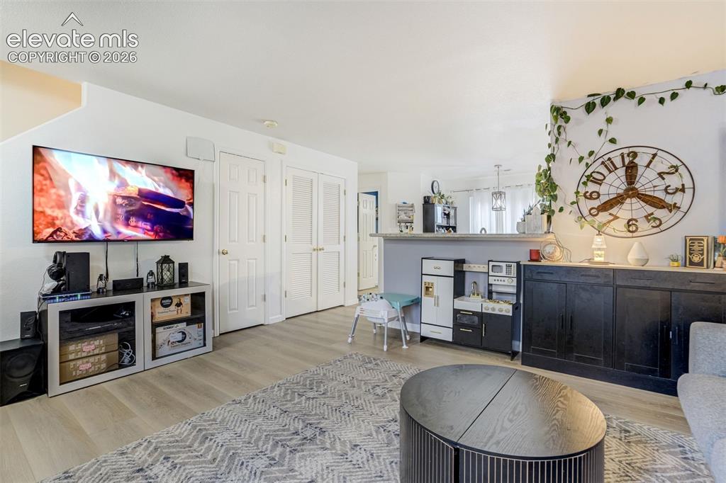 Image 15 of 43: Light-toned wood-finish flooring extends throughout the space