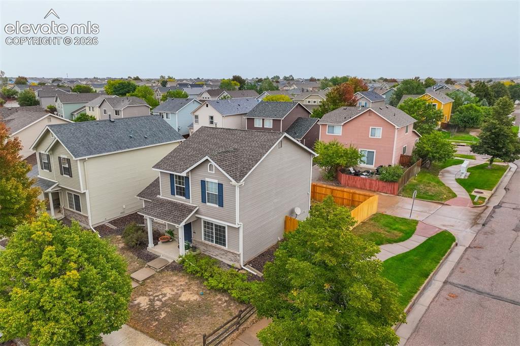 Image 20 of 43: Two-story residence with siding exterior, covered entry, and attached garag