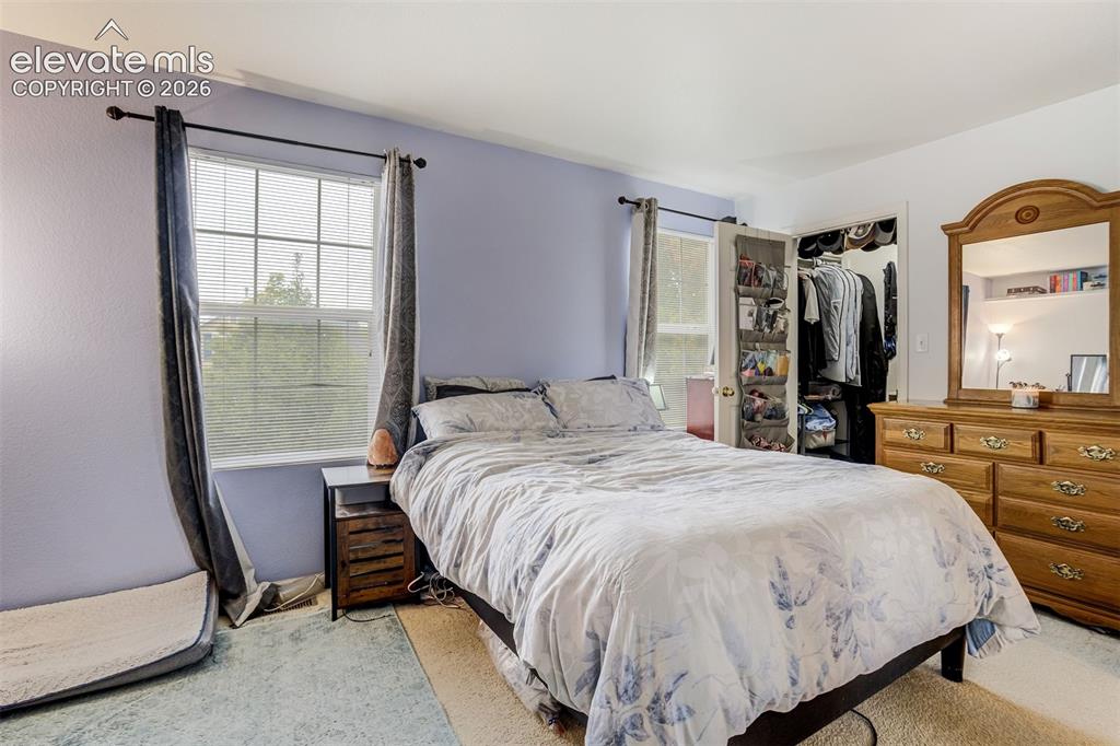 Image 21 of 43: Dual windows with horizontal blinds, providing natural light