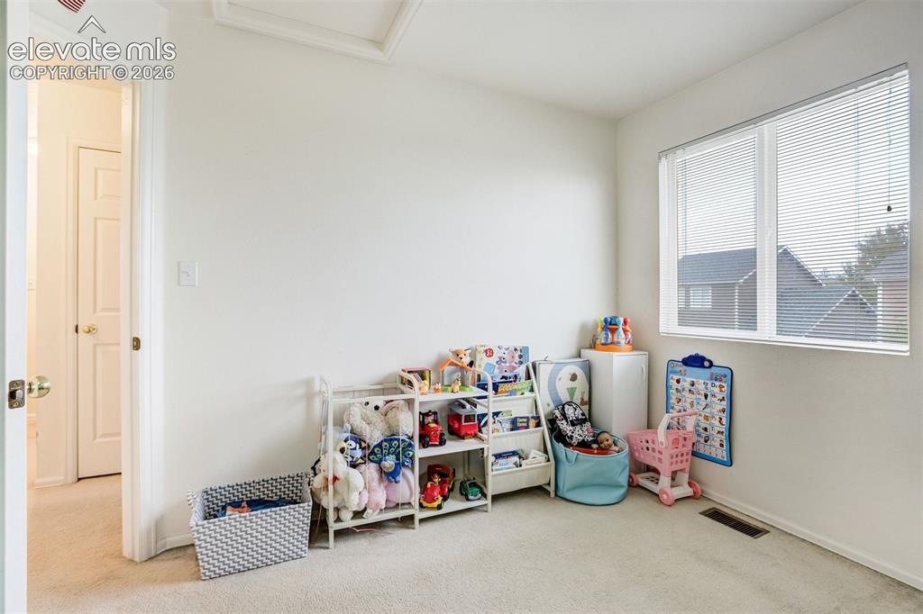 Image 26 of 43: Carpeted room featuring a large window with blinds and white interior doors