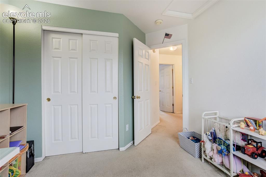 Image 29 of 43: White paneled doors, neutral carpet, and an open doorway