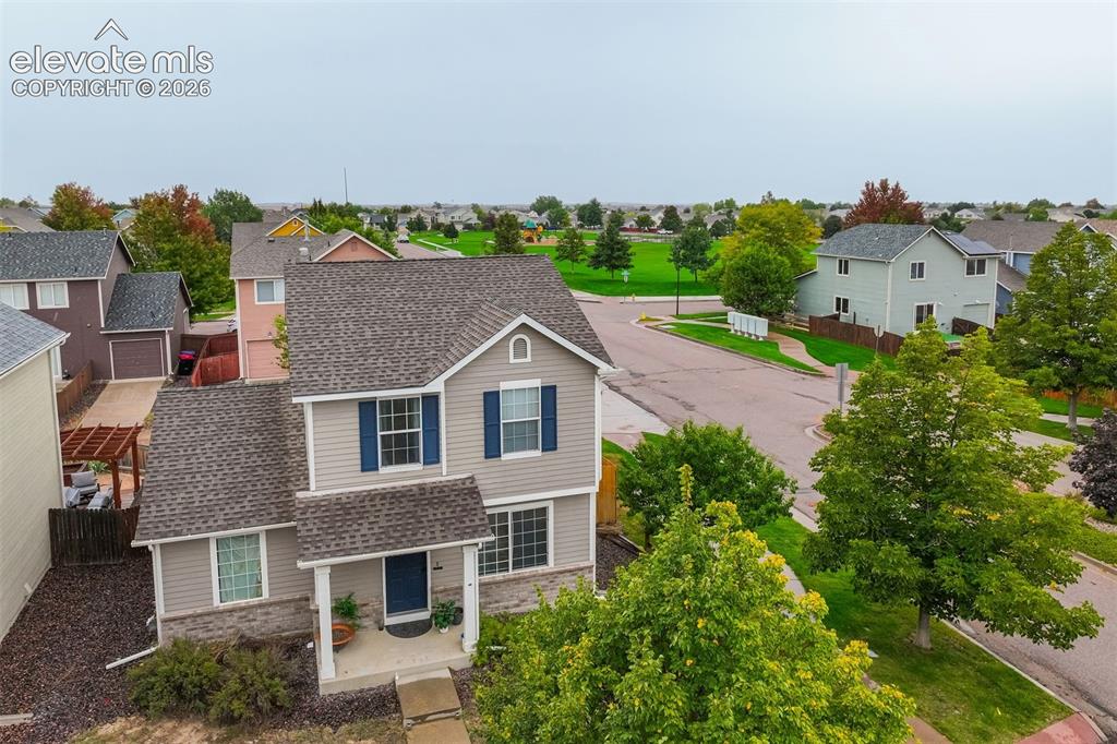 Image 9 of 43: Two-story residence featuring a covered front porch, a two-car garage, and