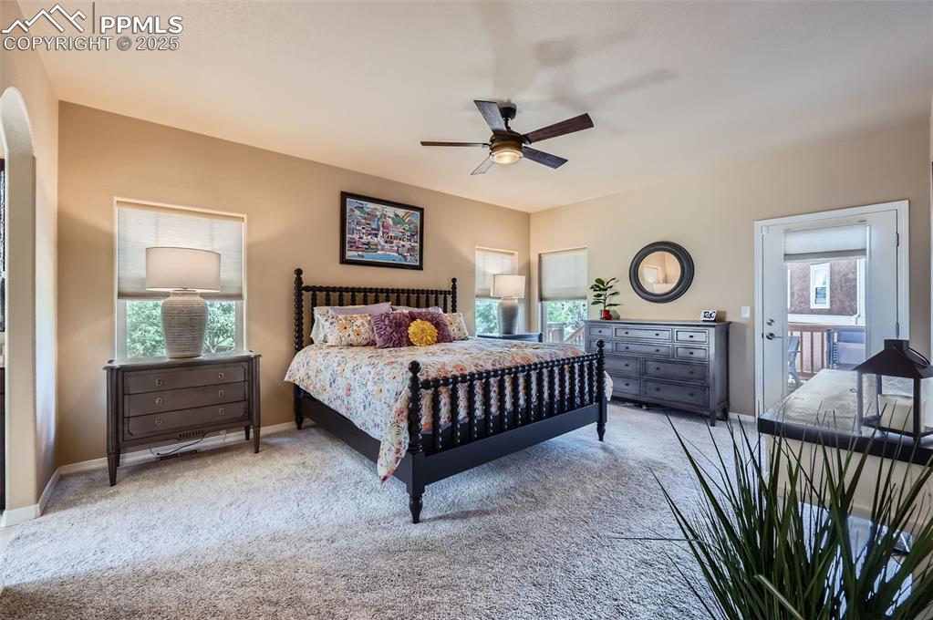 Image 14 of 47: Bedroom featuring carpet floors, arched walkways, and a ceiling fan