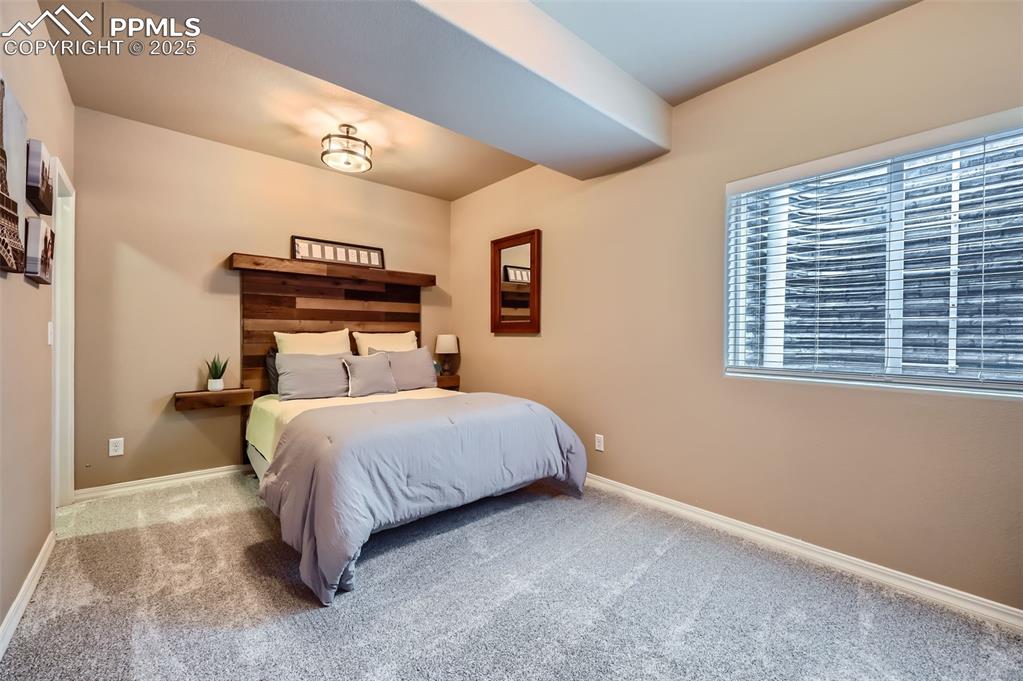 Image 26 of 47: Bedroom with carpet floors and baseboards