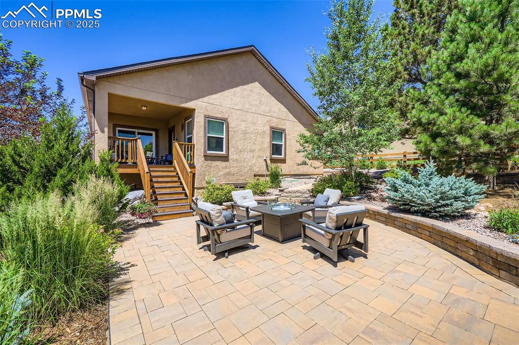 Image 33 of 47: View of patio / terrace with stairway and an outdoor living space with a fi