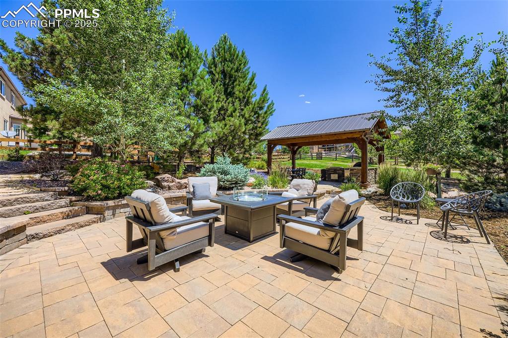 Image 35 of 47: View of patio featuring a gazebo and an outdoor living space with a fire pi