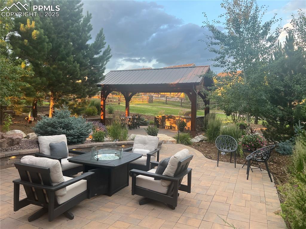 Image 36 of 47: View of patio featuring a gazebo and an outdoor living space with a fire pi