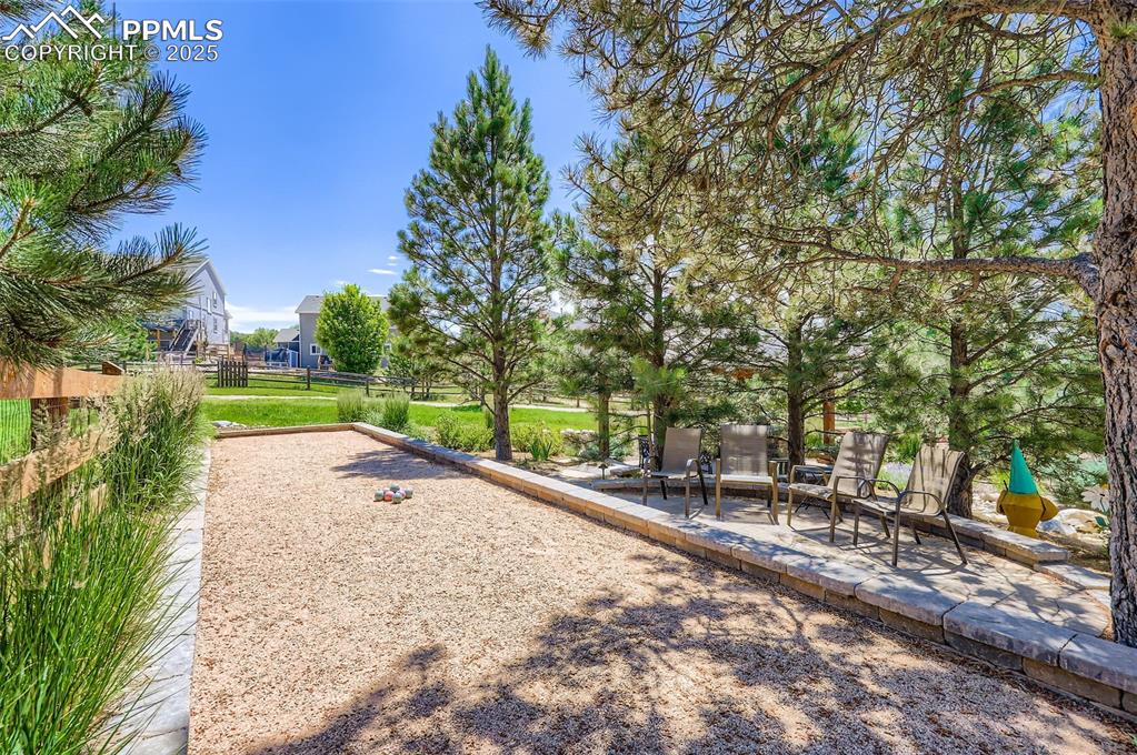 Image 40 of 47: View of yard with a bocce ball area