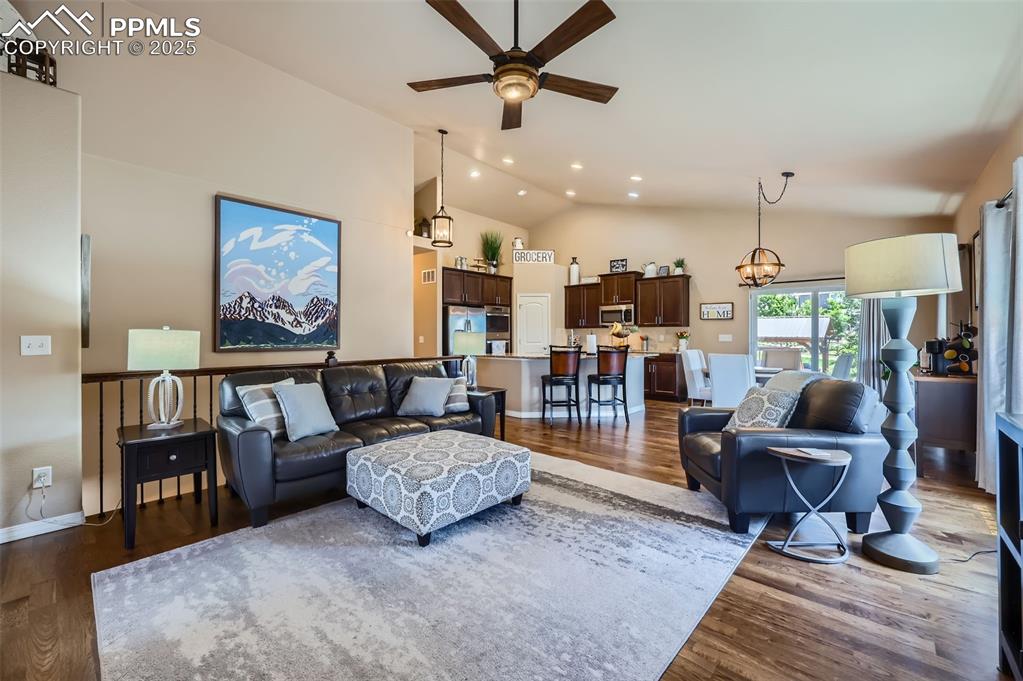 Image 6 of 47: Living area featuring ceiling fan, dark wood-type flooring, recessed lighti