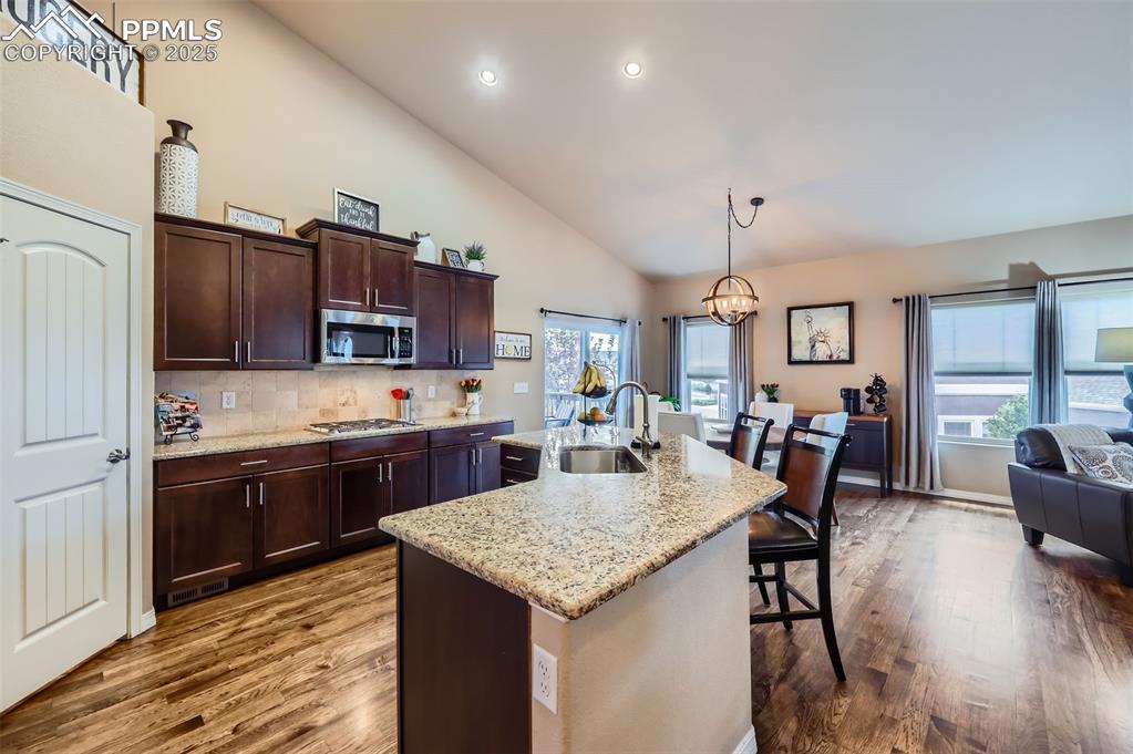 Image 9 of 47: Kitchen featuring high vaulted ceiling, dark wood-style flooring, a kitchen
