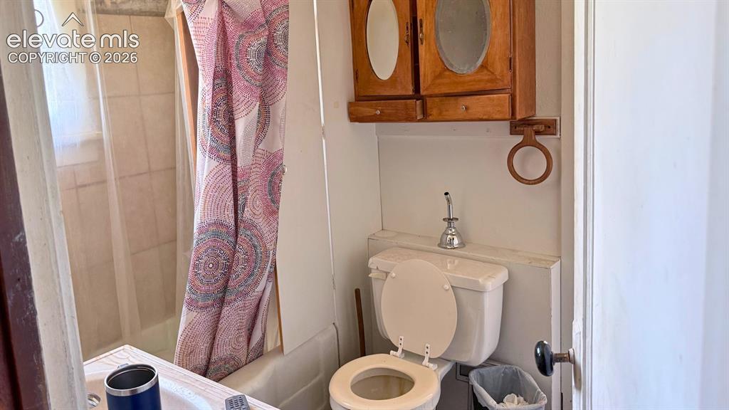 Image 7 of 13: Kitchen space featuring a double-basin sink, laminate countertop, and wood-
