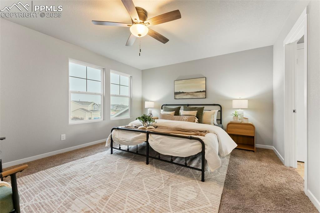Image 16 of 50: Bedroom featuring light carpet and a ceiling fan