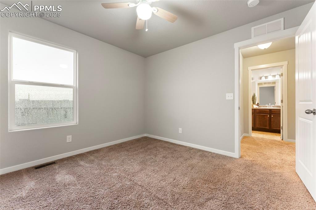 Image 25 of 50: Spare room with light colored carpet and a ceiling fan