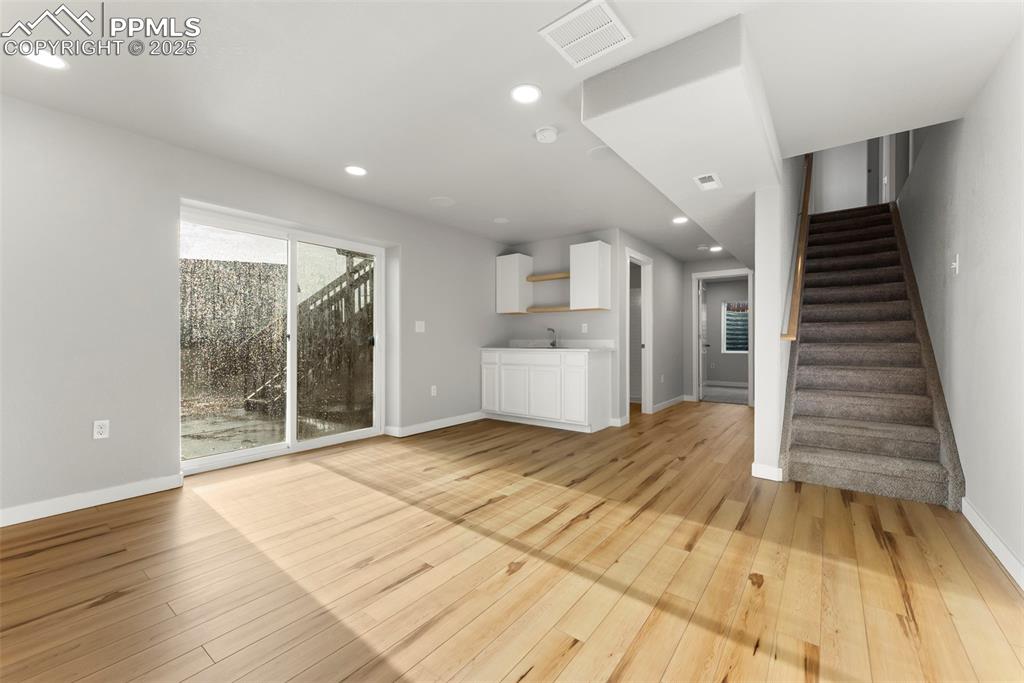 Image 32 of 50: Unfurnished living room with recessed lighting, light wood-type flooring, a