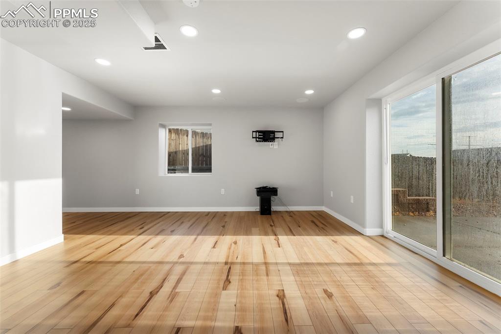 Image 33 of 50: Unfurnished living room featuring recessed lighting, light wood-style floor