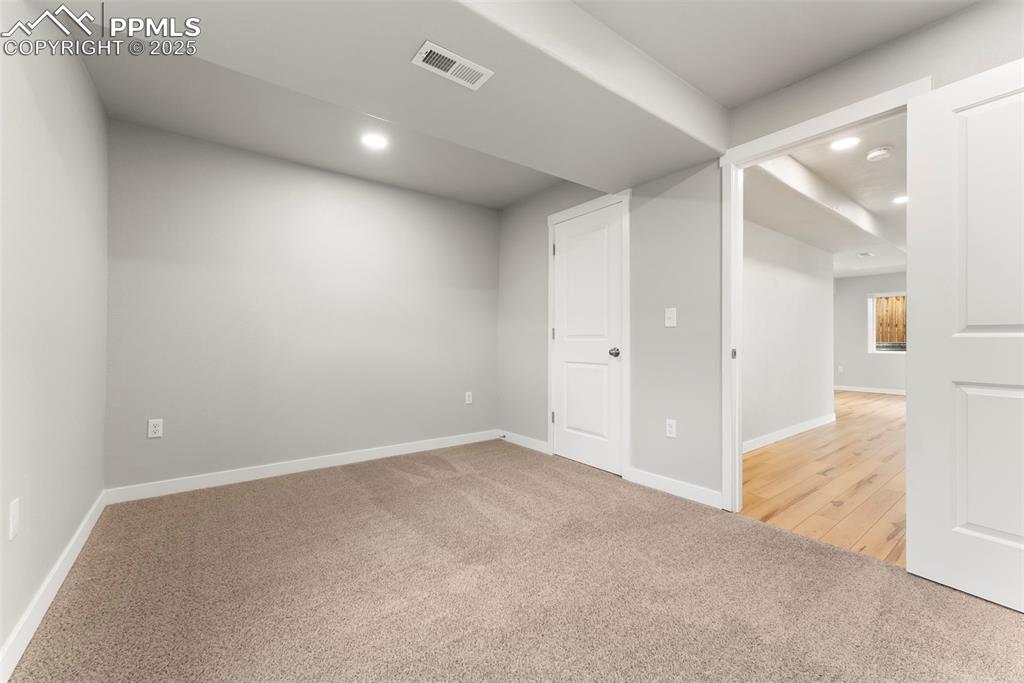 Image 35 of 50: Basement with light carpet and recessed lighting