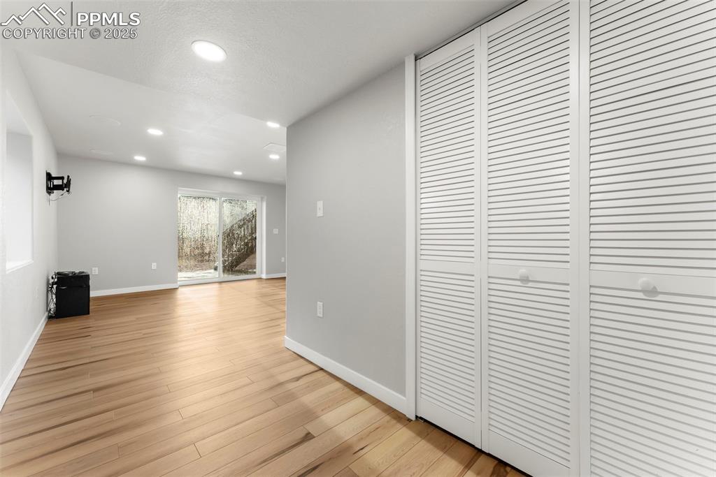 Image 37 of 50: Hallway with recessed lighting and light wood-style floors