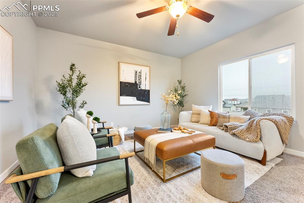 Image 4 of 50: Living area with carpet flooring and ceiling fan