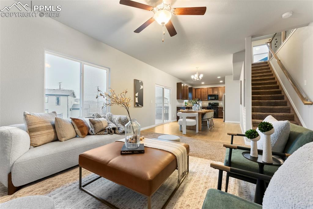 Image 6 of 50: Living area with healthy amount of natural light, light wood-style flooring