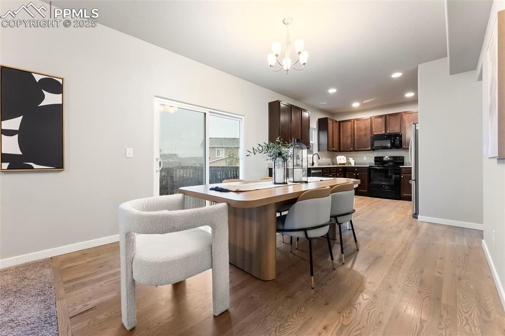 Image 7 of 50: Dining room featuring recessed lighting, light wood-type flooring, and a ch
