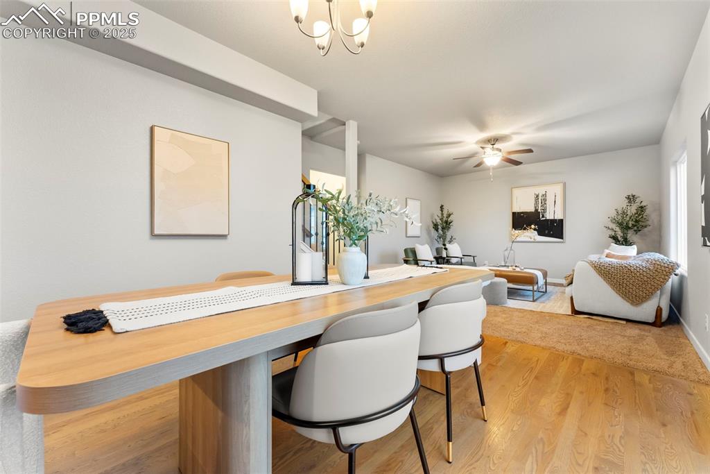 Image 9 of 50: Dining space featuring light wood-style flooring, a chandelier, and a ceili