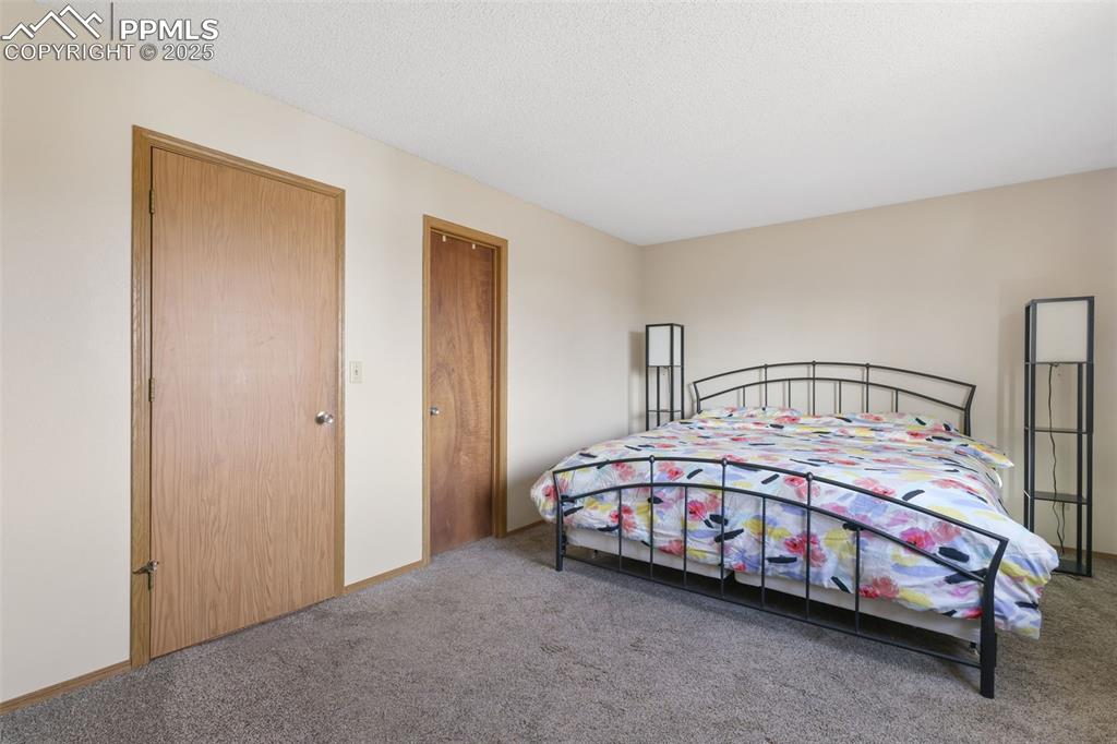 Image 14 of 31: Upper level primary bedroom features a walk-in closet and adjoining full ba