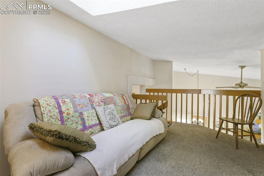 Image 20 of 31: The loft on the uppermost level overlooks the main living area.