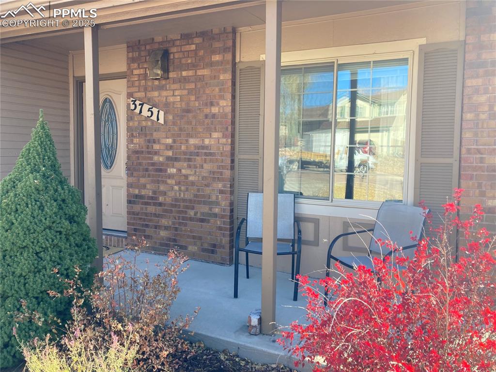 Image 3 of 31: Relax on the front porch while marveling at the Cheyenne Mountain views!