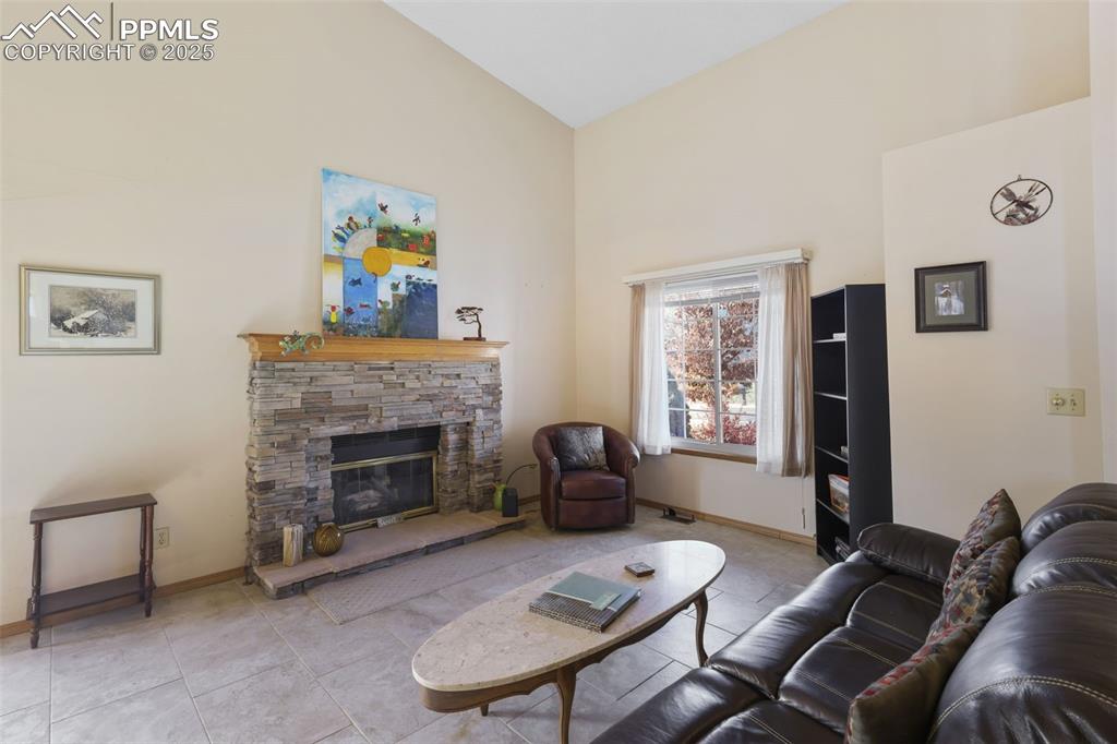 Image 6 of 31: The focal point of the living room is an attractive stacked stone gas firep