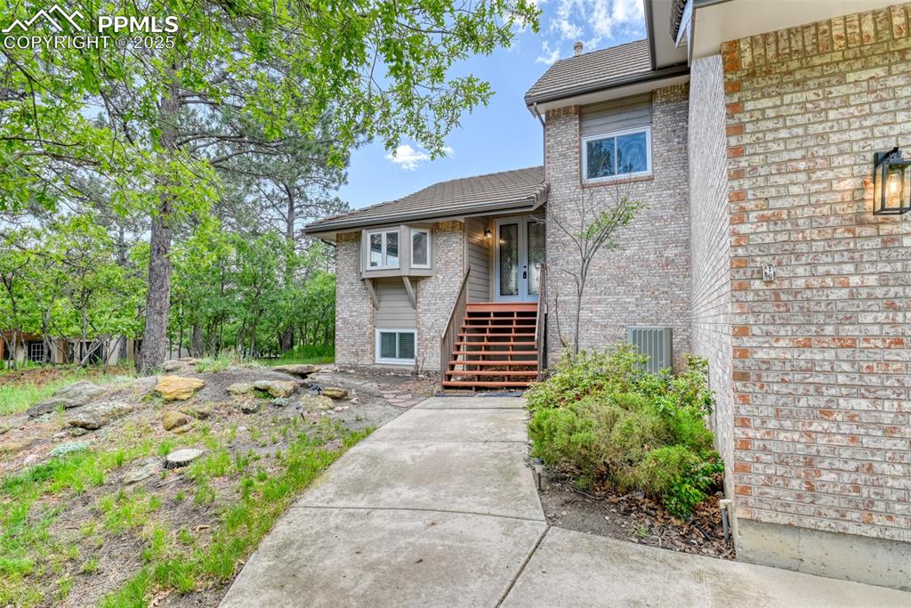 Image 2 of 50: Property entrance featuring brick siding and french doors
