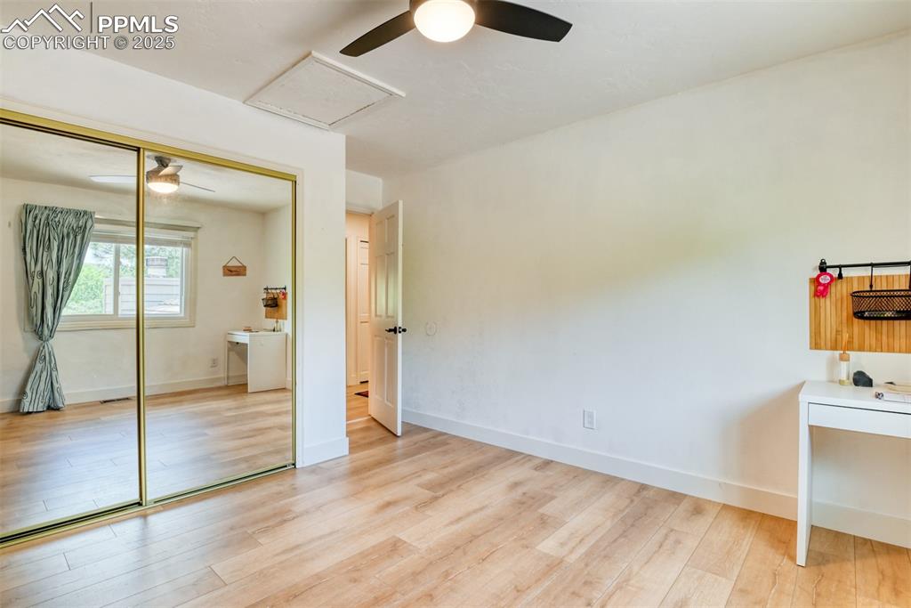 Image 31 of 50: Unfurnished bedroom with light wood-style flooring, a closet, baseboards, a