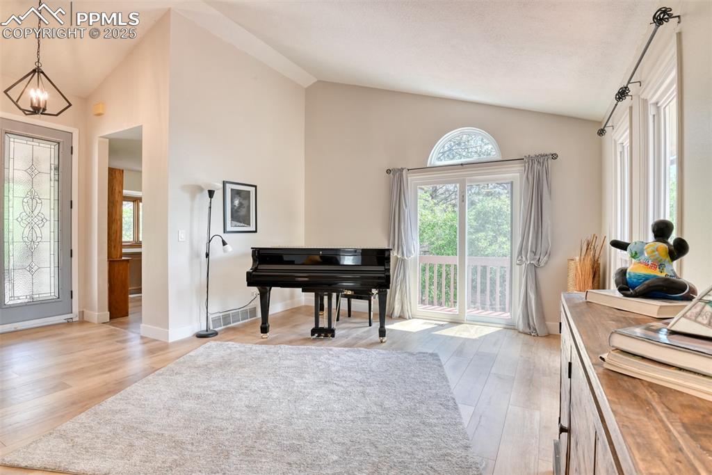 Image 8 of 50: Entryway featuring lofted ceiling, light wood finished floors, plenty of na