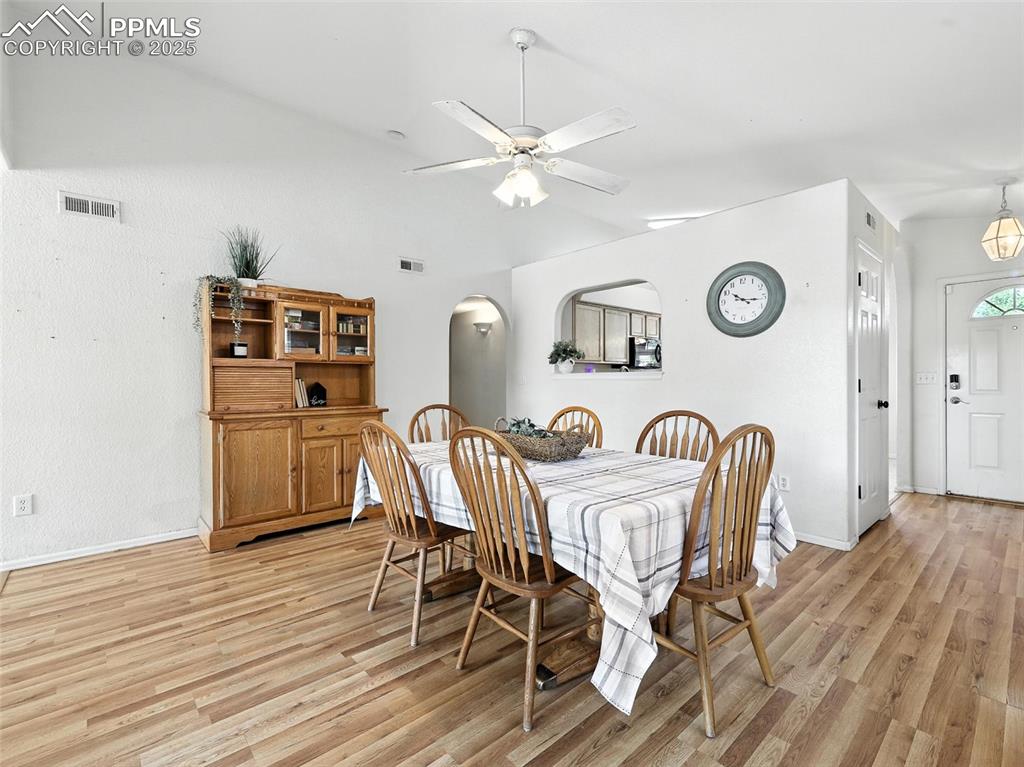 Image 17 of 38: large spacious dining room. Natural hardwood floors throughout entire main