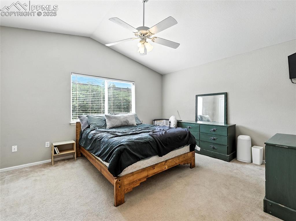 Image 23 of 38: Master bedroom with vaulted ceiling and ceiling fan