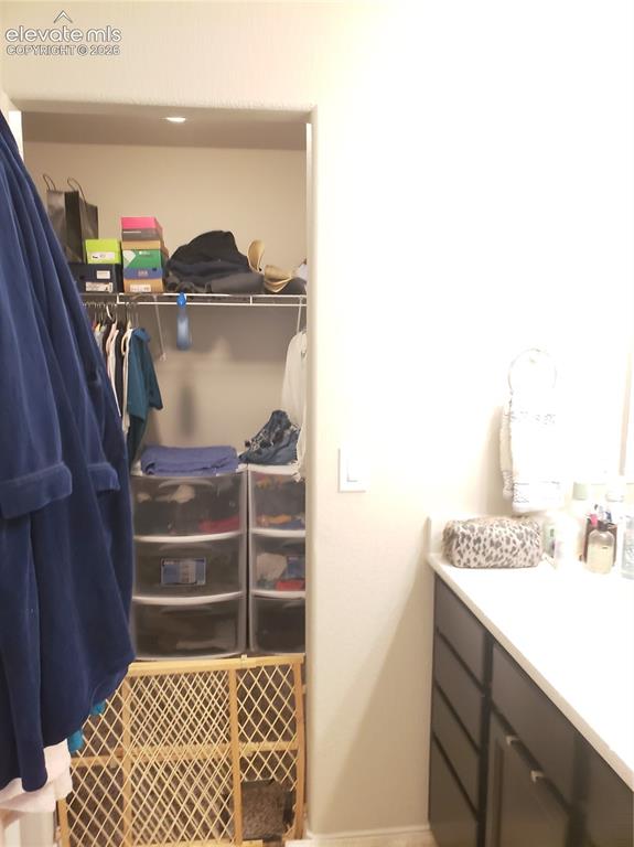 Image 12 of 34: Built-in closet system featuring shelving and hanging rods