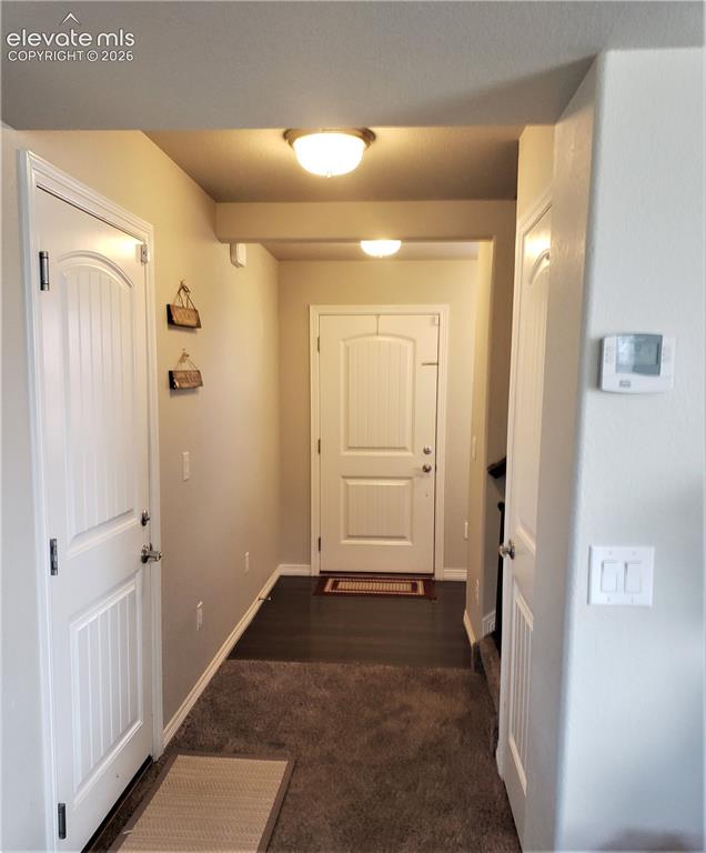Image 16 of 34: Entryway featuring a paneled door, flush-mount lighting, and a combination 