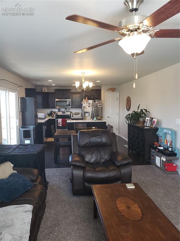 Image 29 of 34: Open concept living space featuring a ceiling fan with integrated lighting,