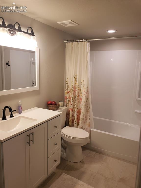 Image 3 of 34: Bathroom featuring a white vanity with an integrated sink, black faucet, an