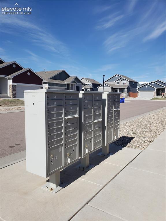 Image 33 of 34: Community mailboxes with a row of residential properties in the background