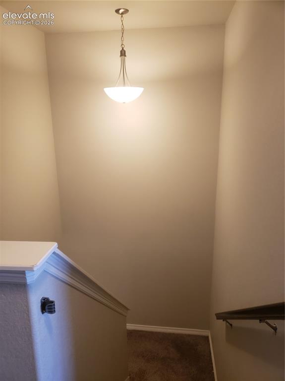 Image 7 of 34: Stairwell featuring a brushed nickel pendant light fixture with a frosted g