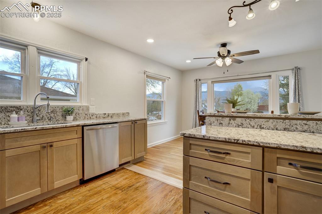 Image 13 of 48: Kitchen featuring stainless steel dishwasher, light wood-type flooring, ple