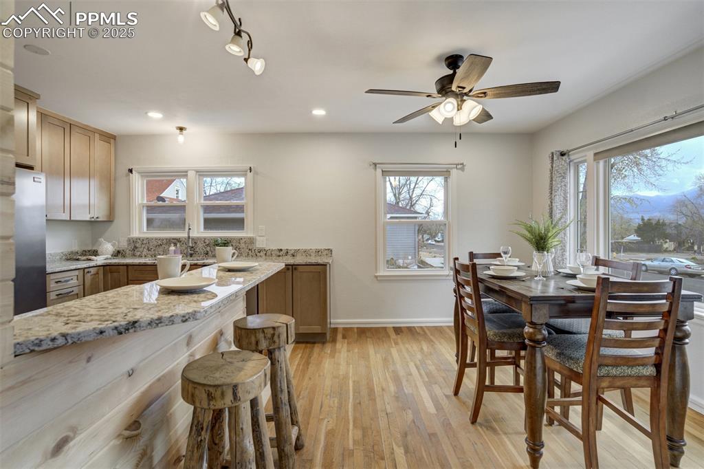 Image 14 of 48: Kitchen featuring light wood-type flooring, healthy amount of natural light
