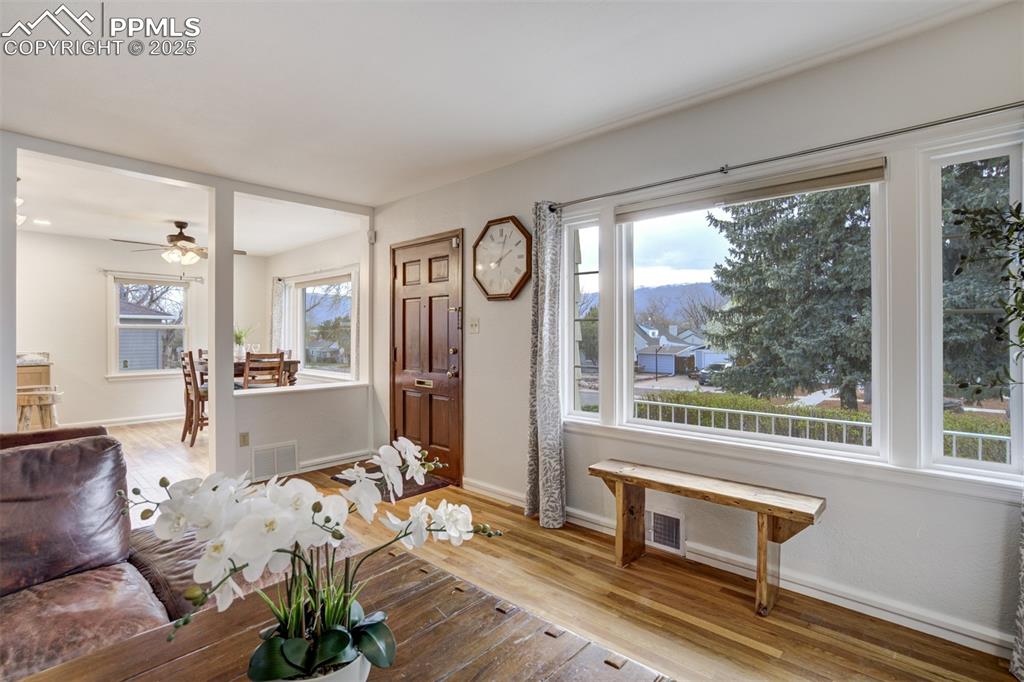 Image 17 of 48: Foyer with light wood finished floors and a ceiling fan