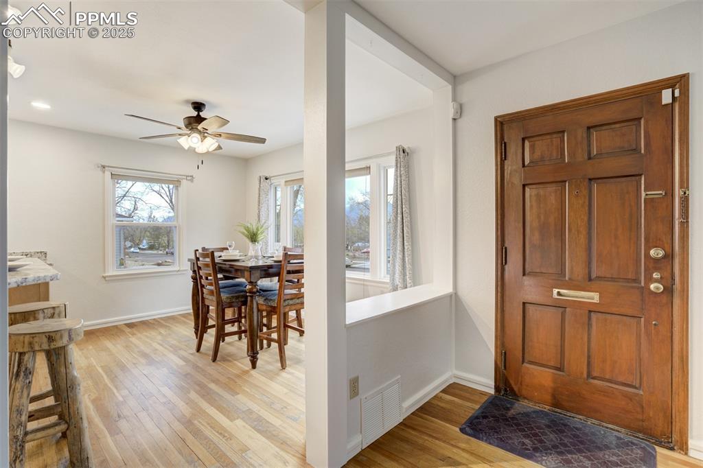 Image 20 of 48: Foyer with light wood finished floors and a ceiling fan