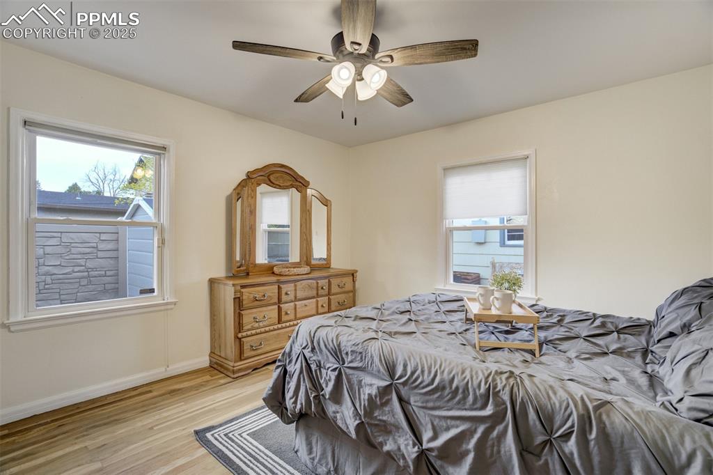 Image 21 of 48: Bedroom featuring light wood finished floors and a ceiling fan
