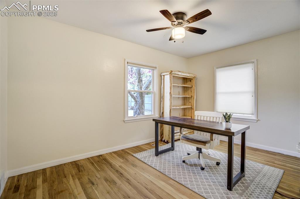 Image 23 of 48: Office featuring wood finished floors and a ceiling fan