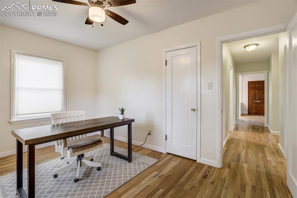 Image 24 of 48: Office with light wood-style flooring and a ceiling fan